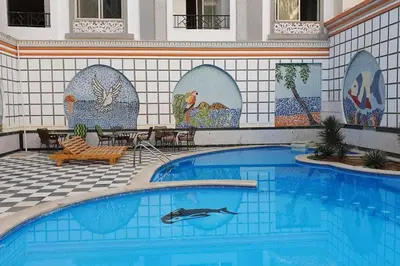 a swimming pool in a resort with a tile wall at 201Sheraton Plaza in Hurghada