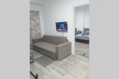 a living room with a couch and a tv at 201Sheraton Plaza in Hurghada