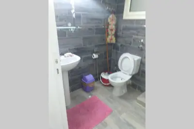 a bathroom with a toilet and a sink at 201Sheraton Plaza in Hurghada