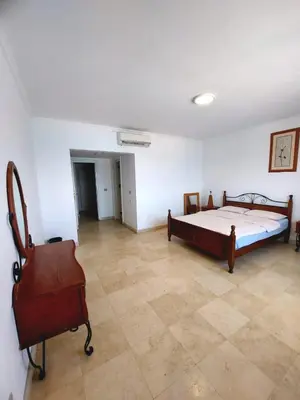 a bedroom with a bed and a chair in it at Amazing 2 bedrooms' Flat Marina El-Hurghadah in Hurghada