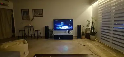 a living room with a flat screen tv on a wall at Amazing 2 bedrooms' Flat Marina El-Hurghadah in Hurghada