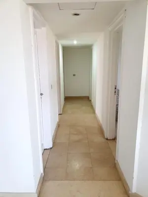 an empty hallway with white walls and a tile floor at Amazing 2 bedrooms' Flat Marina El-Hurghadah in Hurghada