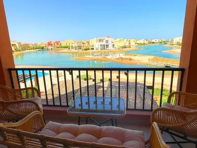 a balcony with chairs and a view of a river at Boho Chic - Scenic Lagoon View at Tawila, Gouna in Hurghada