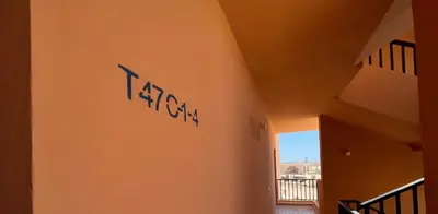 a wall with a sign on the side of a building at Boho Chic - Scenic Lagoon View at Tawila, Gouna in Hurghada