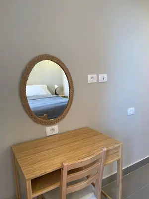 a bedroom with a table and a mirror on the wall at Boho Chic - Scenic Lagoon View at Tawila, Gouna in Hurghada