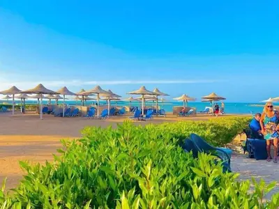 a beach with umbrellas and chairs and the ocean at Turtles Beach Resort - Sea View in Hurghada