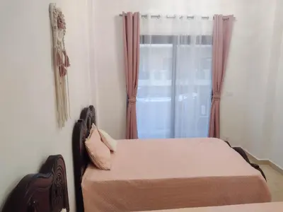 a bedroom with two beds and a window at Turtles Beach Resort - Sea View in Hurghada