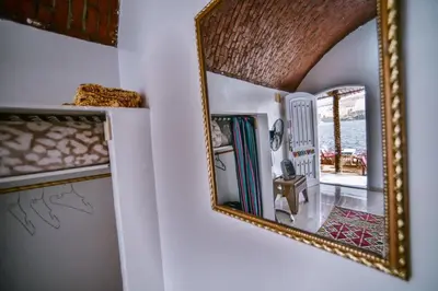 a mirror hanging on a wall next to a hallway at Kafana Guest House Nile View in Aswan