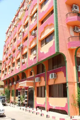 a colorful building with balconies on a street at Tiba Hotel in Aswan