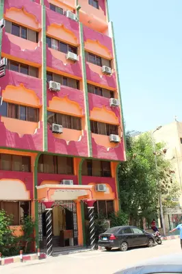 a building with a car parked in front of it at Tiba Hotel in Aswan