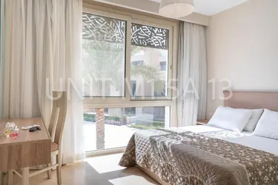 a bedroom with a bed and a large window at Elgouna Heart Mangroovy new 2bedrooms in Hurghada