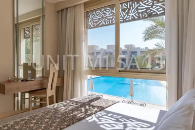 a bedroom with a bed and a desk and a window at Elgouna Heart Mangroovy new 2bedrooms in Hurghada