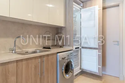 a kitchen with a sink and a washing machine at Elgouna Heart Mangroovy new 2bedrooms in Hurghada