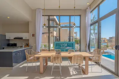 a kitchen and dining room with a wooden table and chairs at La Casa de Playa Tawila on Island 4BR Private with Heated Pool in Hurghada