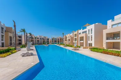a swimming pool in the middle of a building at Mangroovy 3BR Apartment Private Beach & Pool View in Hurghada