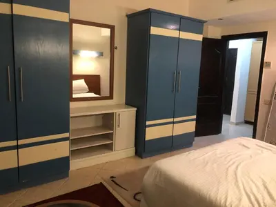 a bedroom with a bed and a large mirror at سهل حشيش in Hurghada