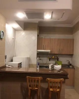 a kitchen with two chairs and a counter top at سهل حشيش in Hurghada