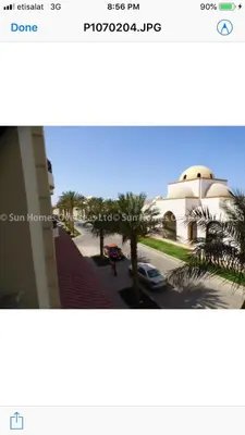 a view of a street with a building and palm trees at سهل حشيش in Hurghada