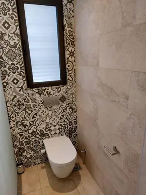 a bathroom with a toilet and a window at El Gouna luxe in Hurghada