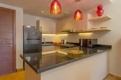 a kitchen with a black counter top in a room at Marina Mosaique 1 BR Apartment with Pool view in Hurghada