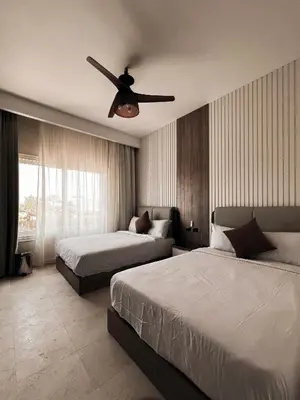 a bedroom with two beds and a ceiling fan at GS 18 Villa in Hurghada