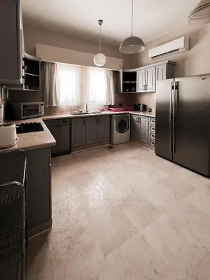 a kitchen with a stainless steel refrigerator and cabinets at GS 18 Villa in Hurghada