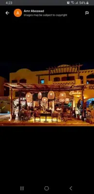 a picture of a house with tables and chairs at Downtown ElGouna Excellent Location in Hurghada