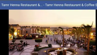 a group of people sitting around a plaza in a city at Downtown ElGouna Excellent Location in Hurghada