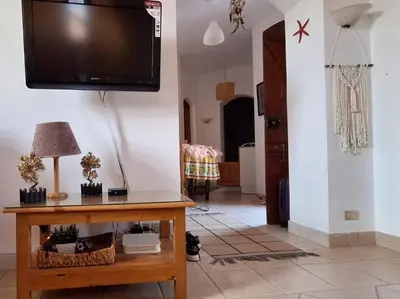 a living room with a tv hanging on the wall at Downtown ElGouna Excellent Location in Hurghada