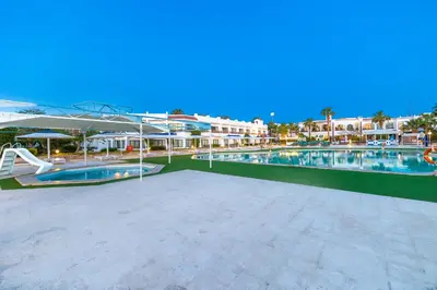 a large swimming pool in a resort at The Grand Hotel, Hurghada in Hurghada