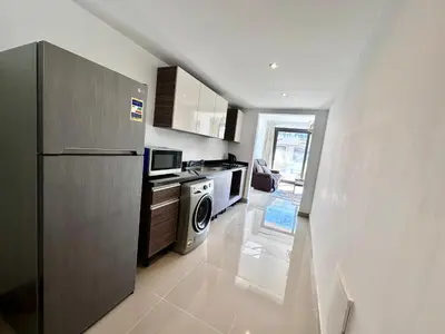 a kitchen with a refrigerator and a microwave at G cribs 2 BR sharing Pool in Hurghada