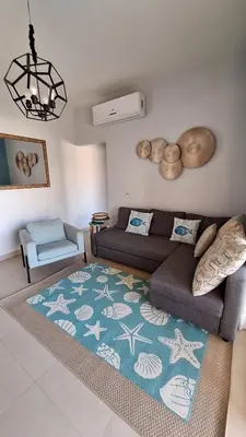 a living room with a couch and a rug at Waterside Apartments, El Gouna - 1Bd Ground Floor in El Gouna