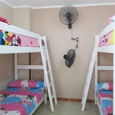 a bedroom with two bunk beds and a fan at Sweet Home Hostel- ممنوع للمصريين open 24 hour in Hurghada