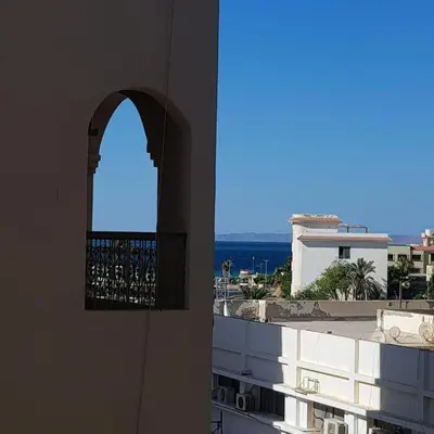 a window in a building with a view of the ocean at Sweet Home Hostel- ممنوع للمصريين open 24 hour in Hurghada