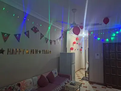 a living room with a happy mixing hall with lights at Sweet Home Hostel- ممنوع للمصريين open 24 hour in Hurghada