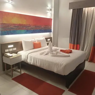 a bedroom with a bed with a painting on the wall at Gloria Aqua Park Hotel in Aswan