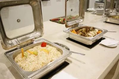 a buffet with two trays of food on a counter at Gloria Aqua Park Hotel in Aswan