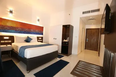 a hotel room with a bed and a bathroom at Gloria Aqua Park Hotel in Aswan