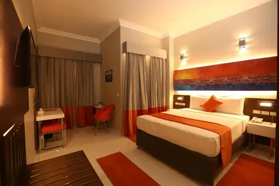 a hotel room with a bed and a desk at Gloria Aqua Park Hotel in Aswan