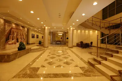 a lobby of a building with stairs and a stair case at Gloria Aqua Park Hotel in Aswan