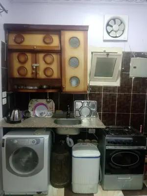 a small kitchen with a stove and a microwave at App12 - RAWDA - Enjoy the privacy of staying in a quiet apartment with free Wi-Fi as your complete second home in the heart of Hurghada in Hurghada