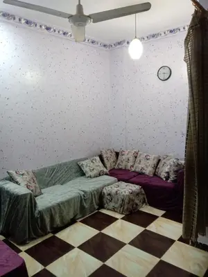 a living room with a couch and a checkered floor at App12 - RAWDA - Enjoy the privacy of staying in a quiet apartment with free Wi-Fi as your complete second home in the heart of Hurghada in Hurghada