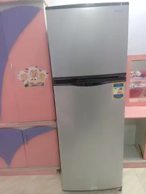 a white refrigerator in a room with a pink wall at App12 - RAWDA - Enjoy the privacy of staying in a quiet apartment with free Wi-Fi as your complete second home in the heart of Hurghada in Hurghada