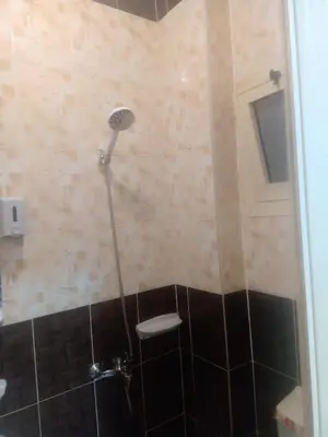 a shower with a shower head in a bathroom at App12 - RAWDA - Enjoy the privacy of staying in a quiet apartment with free Wi-Fi as your complete second home in the heart of Hurghada in Hurghada