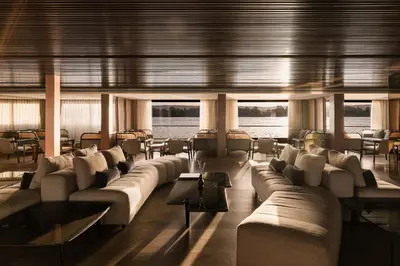 a living room on a boat with couches and tables at Historia The Boutique Hotel Nile Cruise - Every Monday from Luxor for 04 & 07 Nights - Every Friday From Aswan for 03 & 07 Nights in Luxor