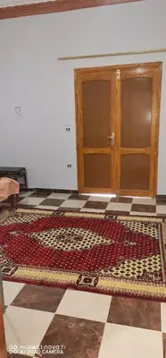 a room with a door and a rug on the floor at Tut flat in Luxor
