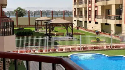 a view from a balcony of a building with a swimming pool at Kemet Apartment luxor in Luxor