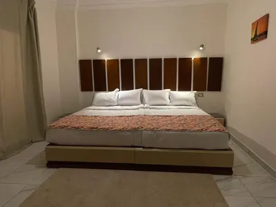 a bedroom with a large bed in a room at Kemet Apartment luxor in Luxor