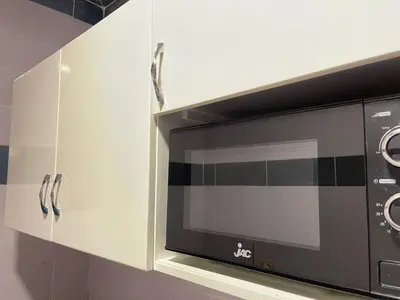 a microwave oven sitting inside of a kitchen cabinets at Kemet Apartment luxor in Luxor