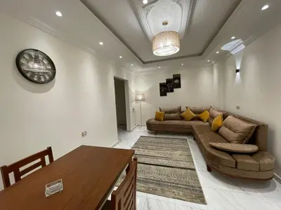 a living room with a couch and a table at Kemet Apartment luxor in Luxor